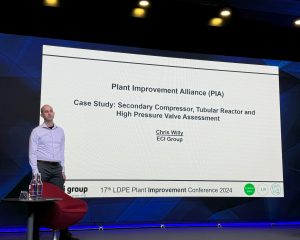 Chris Willy presenting on stage at the conference
